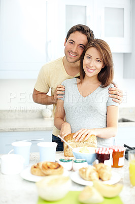 Buy stock photo Pregnant woman, man and portrait with cooking in kitchen, hug or bread for breakfast, diet or nutrition. People, couple and meal prep for pregnancy, smile or prenatal health in morning at family home