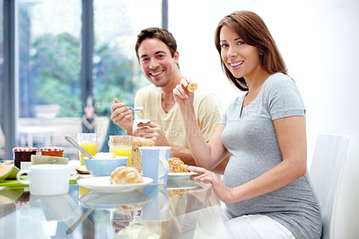 Buy stock photo Pregnant woman, eating or portrait of couple with breakfast for healthy diet or nutrition in home. People, wellness or enjoying meal with pregnancy, smile or prenatal health in morning at family home