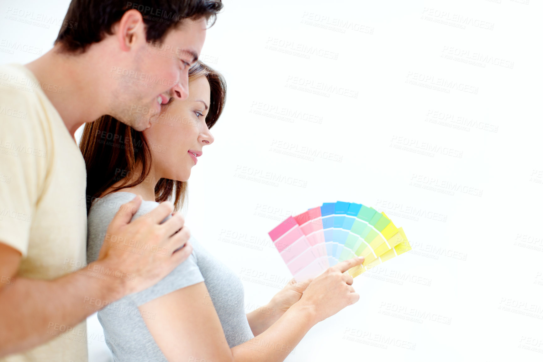 Buy stock photo Young man and woman picking paint color together. Young glad positive couple, husband and wife, choosing color for walls