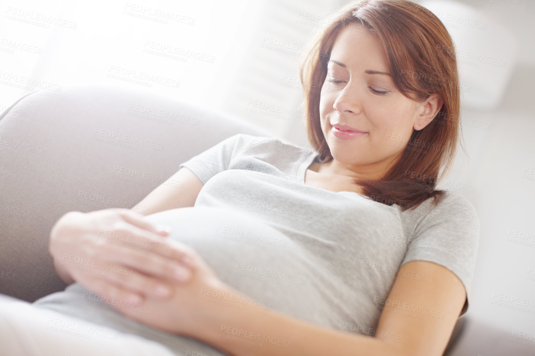 Buy stock photo Pregnant woman, calm and rest in relax, health or happiness for baby development in living room. Female person, comfort and chair as mother for growth on weekend for break, peace and wellness in home