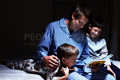 Buy stock photo Children, father and reading bedtime story, fantasy book or brothers learning in dark home at night. Happy kids, dad and storytelling in bedroom for education, fairytale and family bonding together