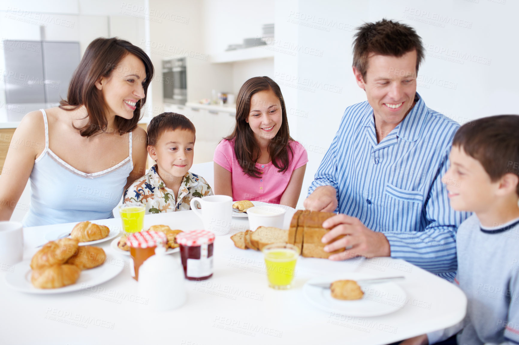 Buy stock photo Family, conversation and morning breakfast in home, dining table and support with healthy food. Parents, children and talking together in kitchen with meal, love and brunch nutrition for bonding