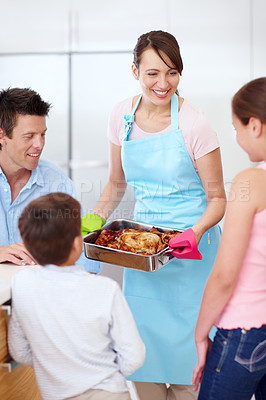 Buy stock photo Parents, kids and happy for food in kitchen with love, cooking and excited for roast. Mother, father and children in home with chicken, family lunch preparation or smile for Thanksgiving celebration