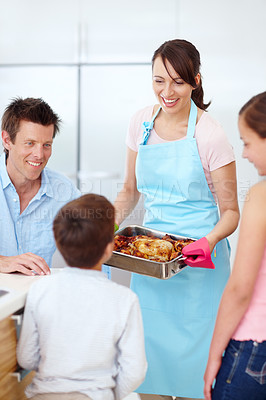 Buy stock photo Parents, children and happy for food in kitchen with love, cooking and excited for roast. Mother, father and kids in home with chicken, family lunch preparation or smile for Thanksgiving celebration