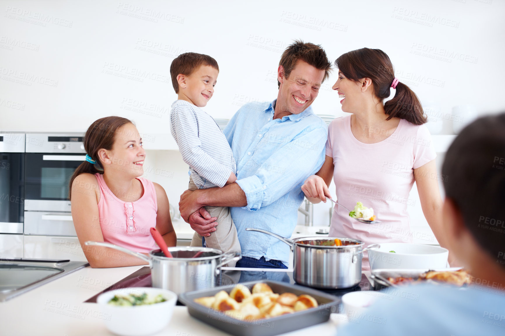 Buy stock photo Family, excited and cooking in kitchen with support, Thanksgiving celebration and love. Parents, children and happy in home for meal preparation, nutritional lunch and smile in apartment for learning