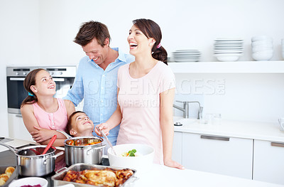 Buy stock photo Family, laughing and cooking at kitchen space with food, Thanksgiving celebration or support. Parents, kids and joking in home with bonding, relationship development and nutritional lunch at stove