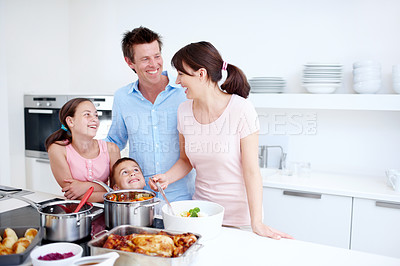 Buy stock photo Family, happy and cooking at kitchen space with food, Thanksgiving celebration and joking. Parents, kids and laughing in home with bonding, relationship development and nutritional lunch at stove