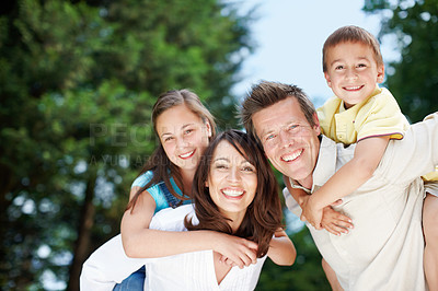 Buy stock photo Family, park and portrait outdoor with piggy back, game and smile with mom, dad and kids with fun. Bonding, love and care with happy youth and hug in nature with trees, weekend and break in garden