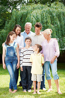 Buy stock photo Happy, big family or laughing with hug in nature for holiday, weekend or bonding together. Grandparents, parents and children or kids with smile or generations for outdoor vacation or support at park