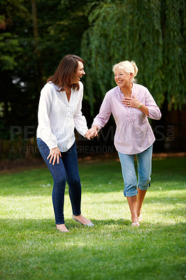 Buy stock photo Outdoor, senior mother and woman with holding hands for walking, connection and bonding together. Happy people, mom and adult daughter with laugh for memory, security and love on holiday in park