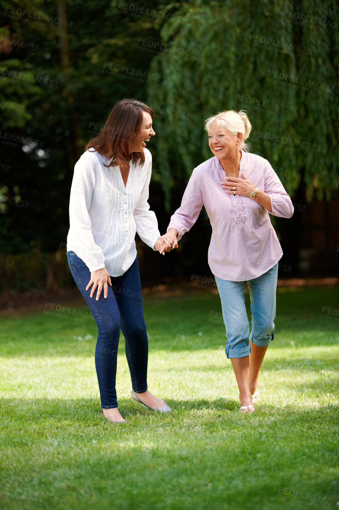 Buy stock photo Outdoor, senior mother and woman with holding hands for walking, connection and bonding together. Happy people, mom and adult daughter with laugh for memory, security and love on holiday in park