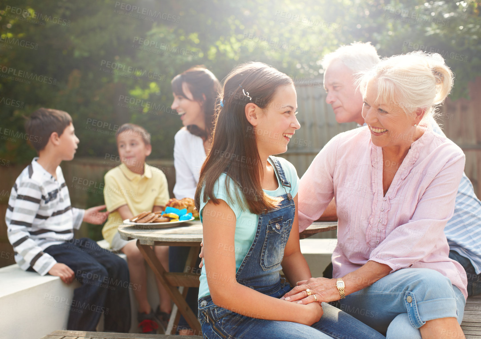 Buy stock photo Outdoor, grandma and child with laughing for love, connection and bonding together with lunch. Happy people, senior woman and girl with smile for care embrace, security and trust for brunch snack