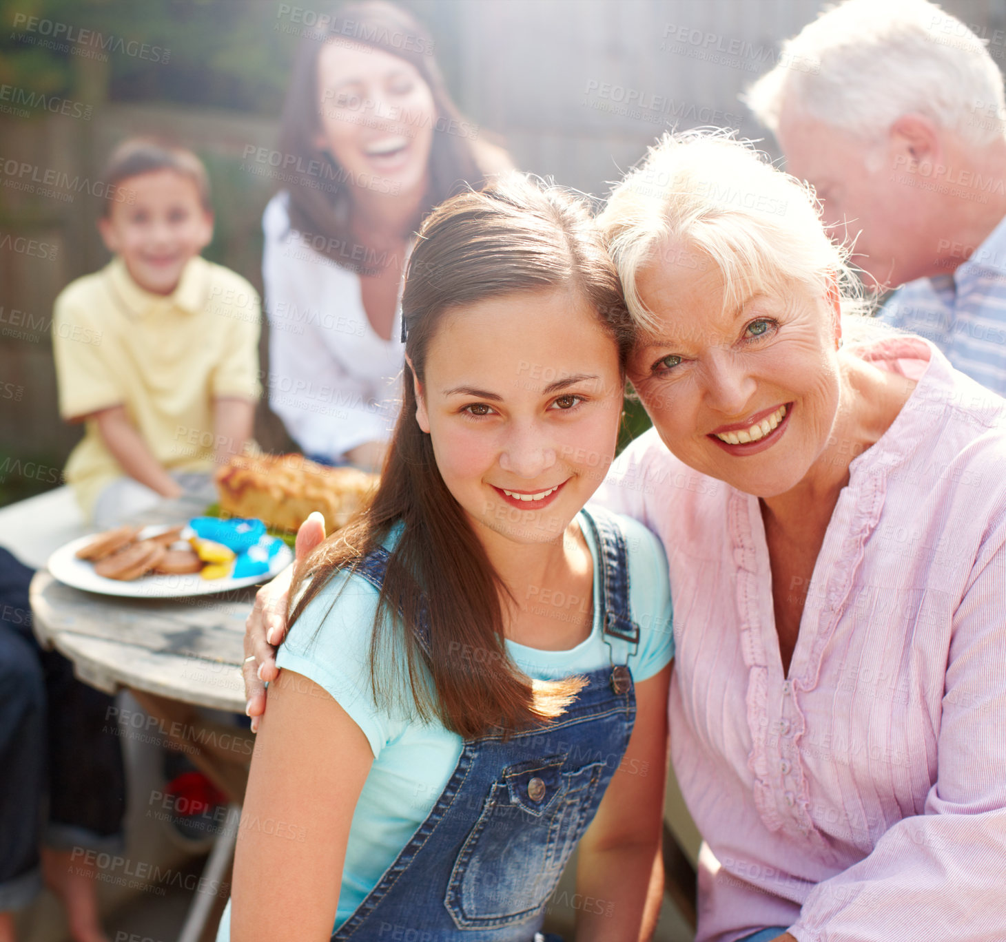 Buy stock photo Outdoor, grandma and child in portrait with hug, connection and bonding together with lunch. Happy people, senior woman or girl with smile for love embrace, security or care with joy for brunch snack