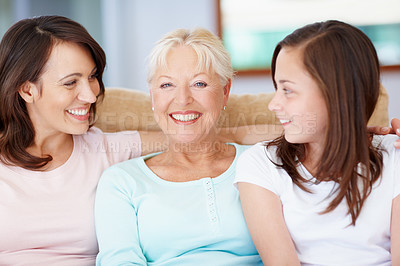 Buy stock photo A happy grandmother sitting with her daughter and granddaughter smiling widely