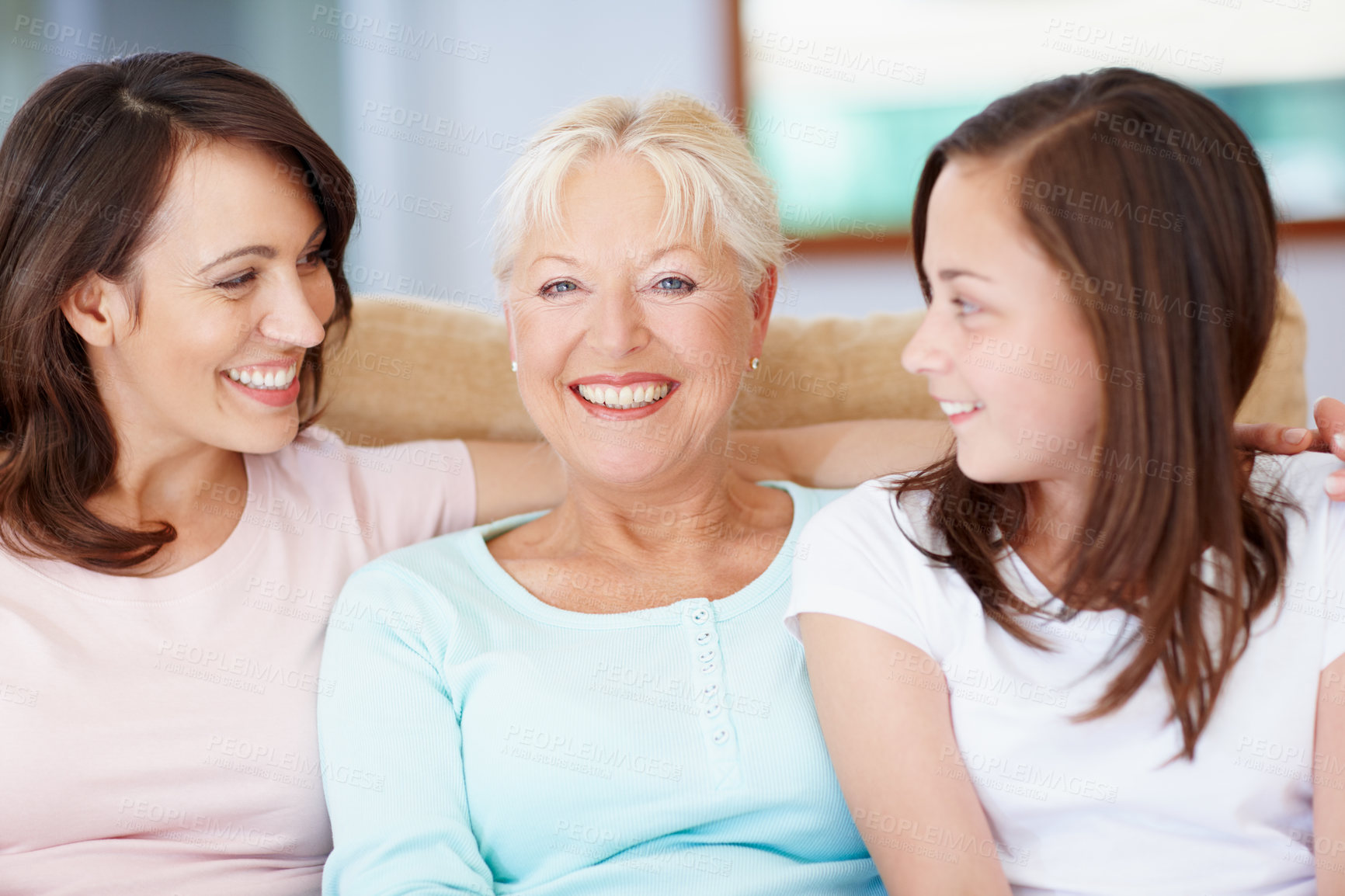 Buy stock photo A happy grandmother sitting with her daughter and granddaughter smiling widely