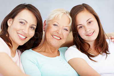 Buy stock photo Family, portrait and home with women, girl and grandmother together with care on sofa. Female generations, happy and smile with love, bonding and support with hug and relax in living room on weekend