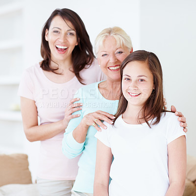 Buy stock photo Portrait of a granddaughter, mother and grandmother laughing happily while holding one another in a line