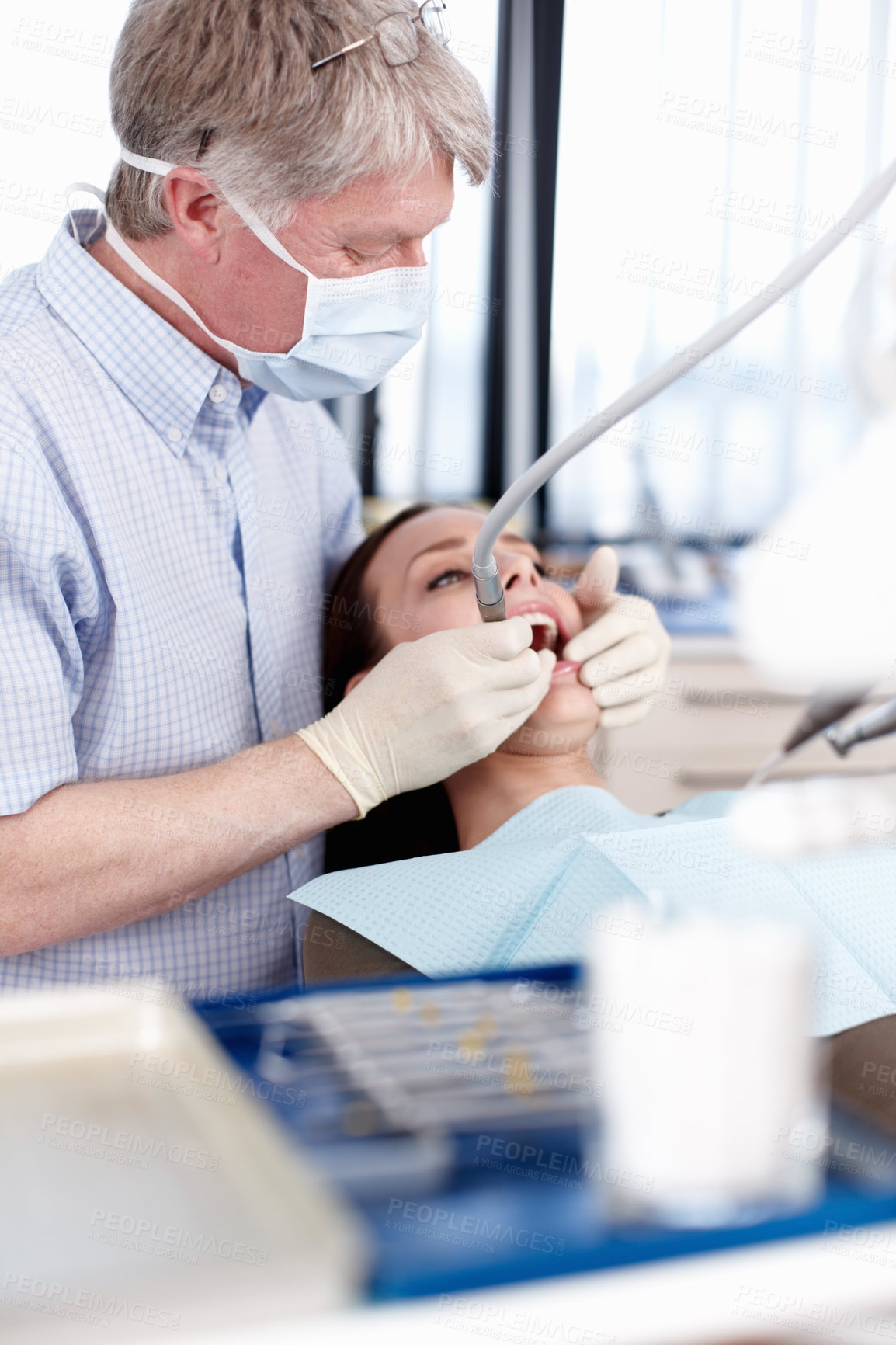 Buy stock photo Man, dentist and woman for checkup at clinic of cleaning treatment, bacteria assessment and teeth whitening. Mature, orthodontics and patient for equipment, root canal and veneer inspection of dental