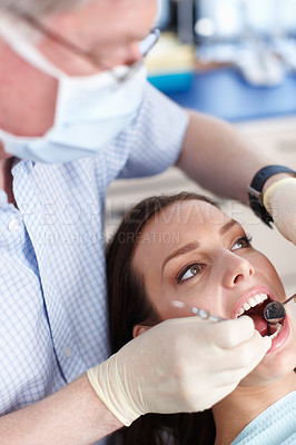 Buy stock photo High angle view of dentist cleaning patient's teeth