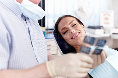 Buy stock photo Portrait of dentist showing x-ray to female patient in clinic