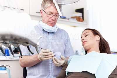 Buy stock photo Portrait of dentist holding false teeth with female patient in clinic