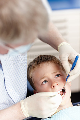Buy stock photo High angle view of doctor checking boy's teeth in clinic