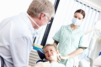 Buy stock photo Portrait of young boy smiling at dentist with assistant in office