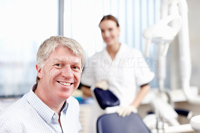Buy stock photo Portrait of handsome dentist smiling with his assistant in office