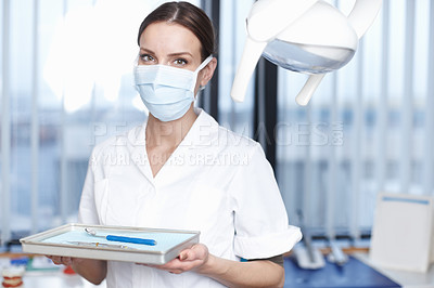 Buy stock photo Portrait of young female dentist holding tools for dental operation