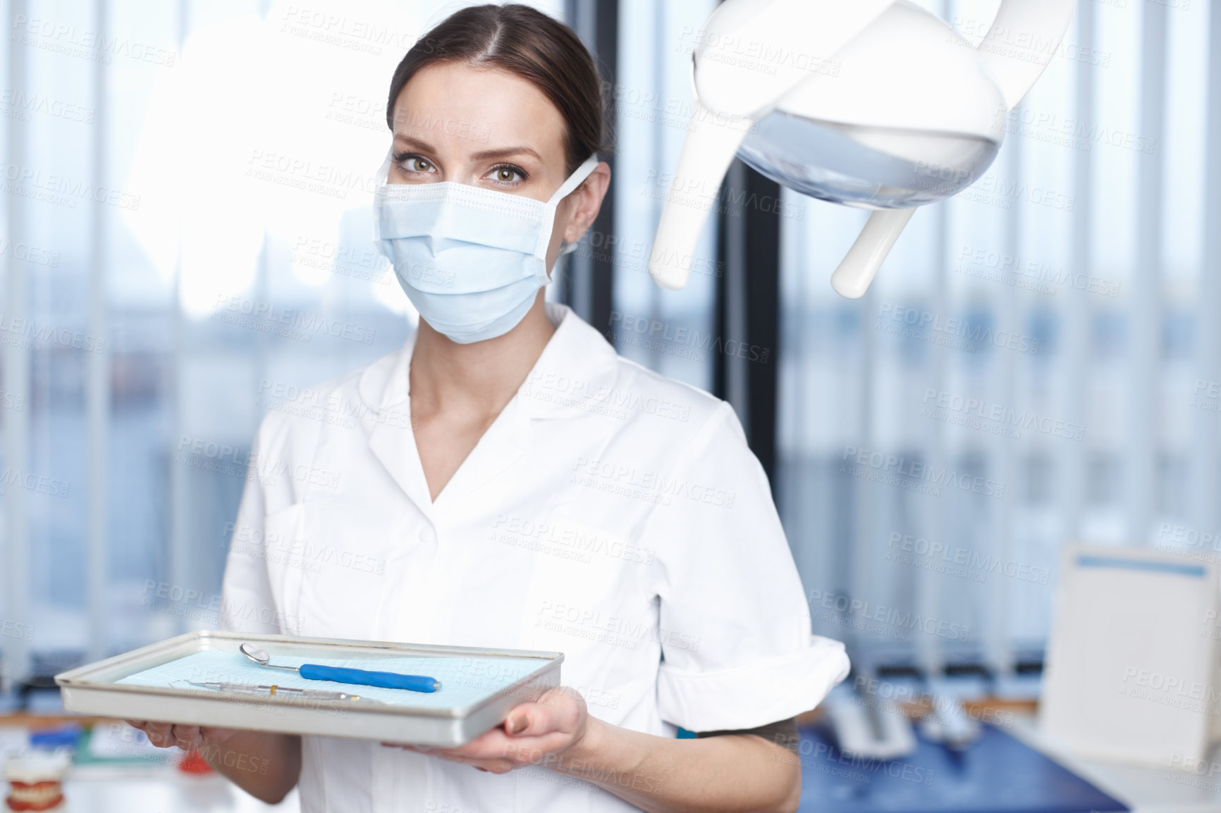 Buy stock photo Portrait, dentist and woman with tools, mask and confident for dental health, office and oral hygiene. Hospital, medical professional and person in uniform for tooth extraction, proud and Germany