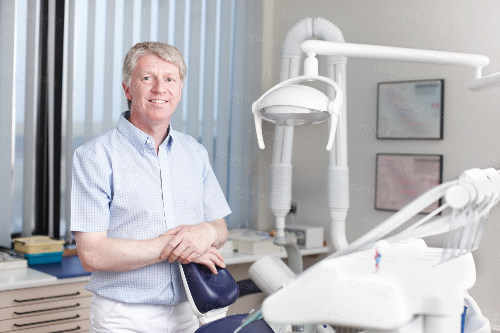 Buy stock photo Man, dentist and portrait in office for healthcare, business and friendly welcome. Mature orthodontist, equipment and smile in private practice with pride for knowledge in oral hygiene in Canada