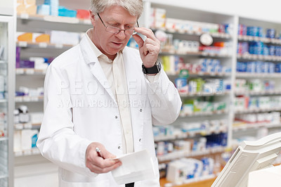 Buy stock photo Portrait of pharmacist going through prescription at drugstore