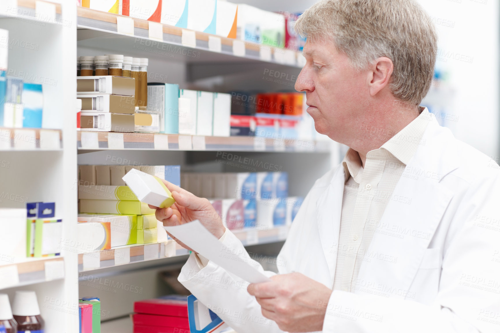 Buy stock photo Mature pharmacist, prescription and medication in pharmacy for pills dispensary and healthcare service. Medical professional, employee and man in pharmaceutical store for patient treatment or package