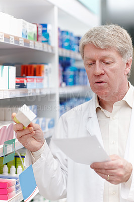 Buy stock photo Man, pharmacist and reading prescription for medication, pills and drug store with box for healthcare. Mature person, shelf and pharmacy with checklist for product, medicine and treatment or stock