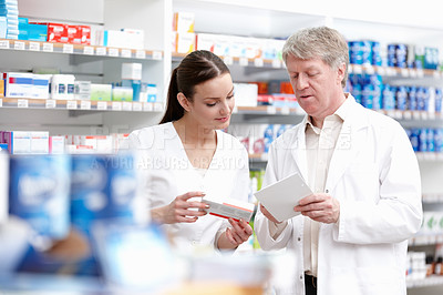 Buy stock photo Employees, pharmacists and reading prescription for medication, pills and information at drugstore box. People, pharmacy and serious with checklist for product, medicine and treatment for healthcare