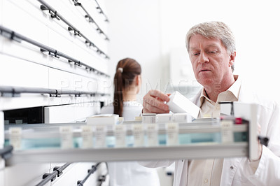 Buy stock photo Pharmacist, inventory and team for medicine, pills and stock in drugstore, chemist or services. Medical professional, male person and pharmacy with prescription, dispensary and info as advice or care