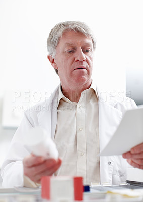 Buy stock photo Pharmacist, inventory and reading for medicine, pills or stock in drugstore, chemist or services. Medical professional, male person and pharmacy as prescription, dispensary or info for advice or care