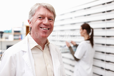 Buy stock photo Mature pharmacist, man and portrait in pharmacy for medication dispensary and healthcare service. Medical professional, employee and happy in pharmaceutical store for prescription drugs or assistance