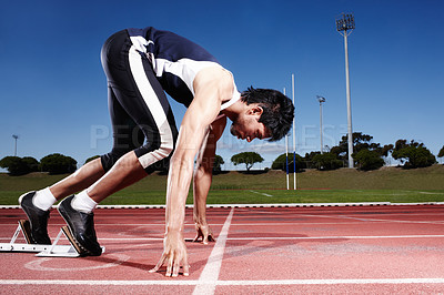 Buy stock photo A young runner getting ready for a race