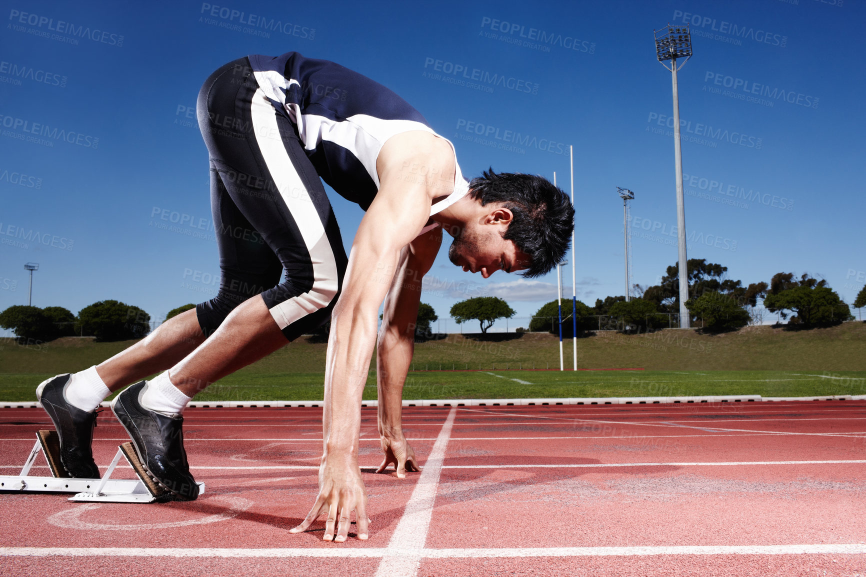 Buy stock photo A young runner getting ready for a race