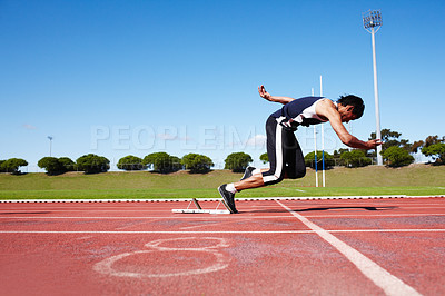 Buy stock photo A young athlete ready to run a race