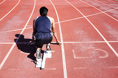 Buy stock photo Field runner, back and man at start block at track for race, sports competition and training for fitness. Arena, ready and athlete prepared for sprint, speed and fast performance outdoor at stadium