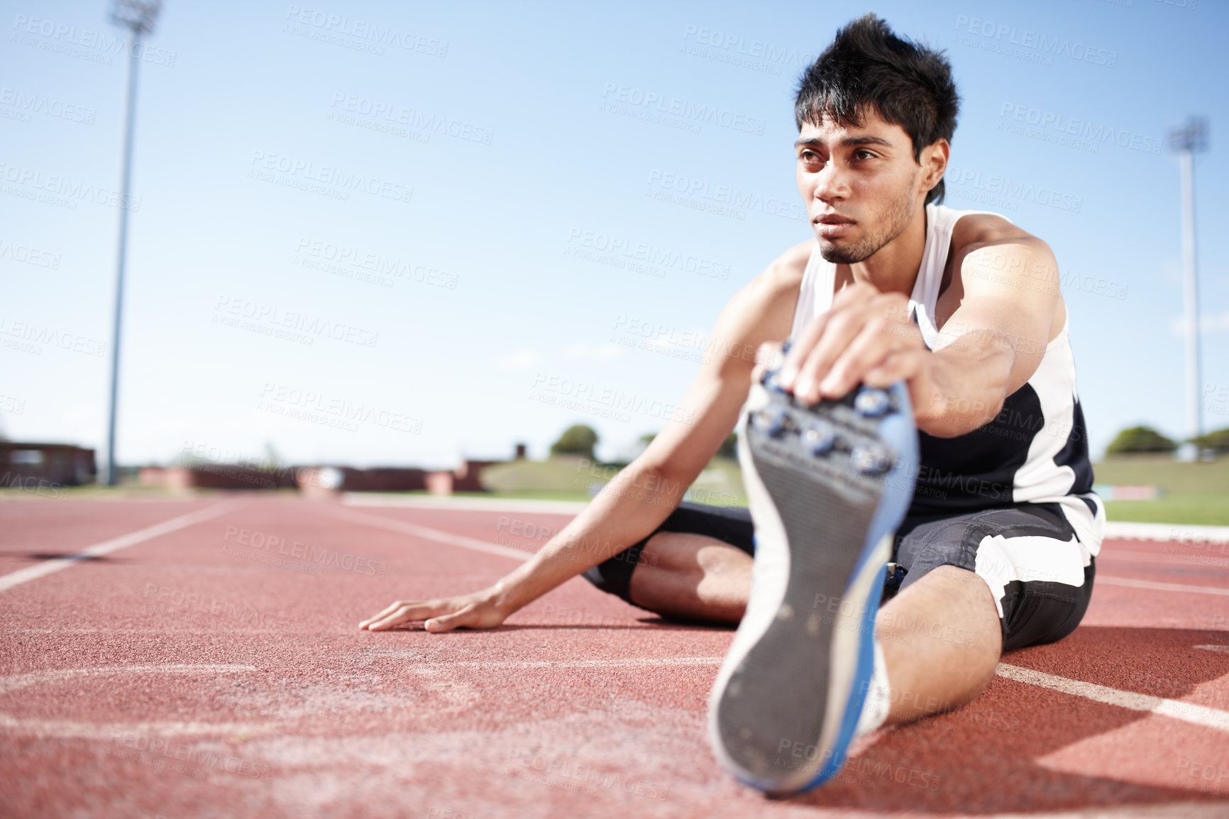 Buy stock photo Man, ground and stretching legs on running track, warm up and preparation for exercise or workout. Male person, muscle relief and outdoor for fitness in sport, athlete and ready for marathon training