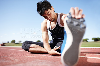 Buy stock photo Man, workout and stretching legs on running track, warm up and preparation for exercise on ground. Male person, start and outdoor for fitness in sportswear, athlete and ready for marathon training