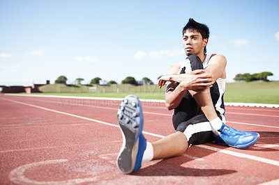 Buy stock photo Man, action and stretching legs on running track, warm up and preparation for exercise or workout. Male person, start and outdoor for fitness in sportswear, athlete and ready for marathon training