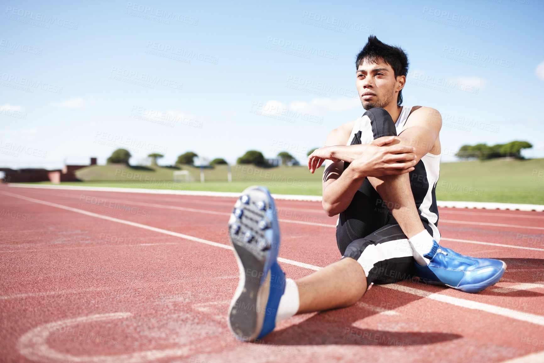 Buy stock photo Man, action and stretching legs on running track, warm up and preparation for exercise or workout. Male person, start and outdoor for fitness in sportswear, athlete and ready for marathon training