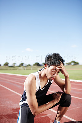 Buy stock photo Tired, man and runner on track for running with training for race, marathon or competition. Exhausted, break and male long distance athlete with conditioning, challenge and cardio workout at stadium.