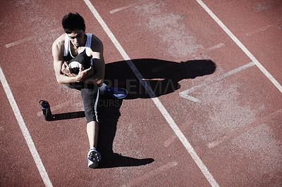 Buy stock photo Man, athlete and stretching legs on running track, warm up and preparation for exercise or workout. Male person, starting block and outdoor for fitness, water bottle and ready for marathon training