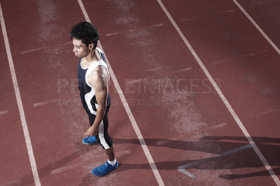 Buy stock photo Fitness, runner or top view of man on track for training, outdoor workout or sports exercise. Night, healthy and confident male athlete waiting in stadium for running development or race performance