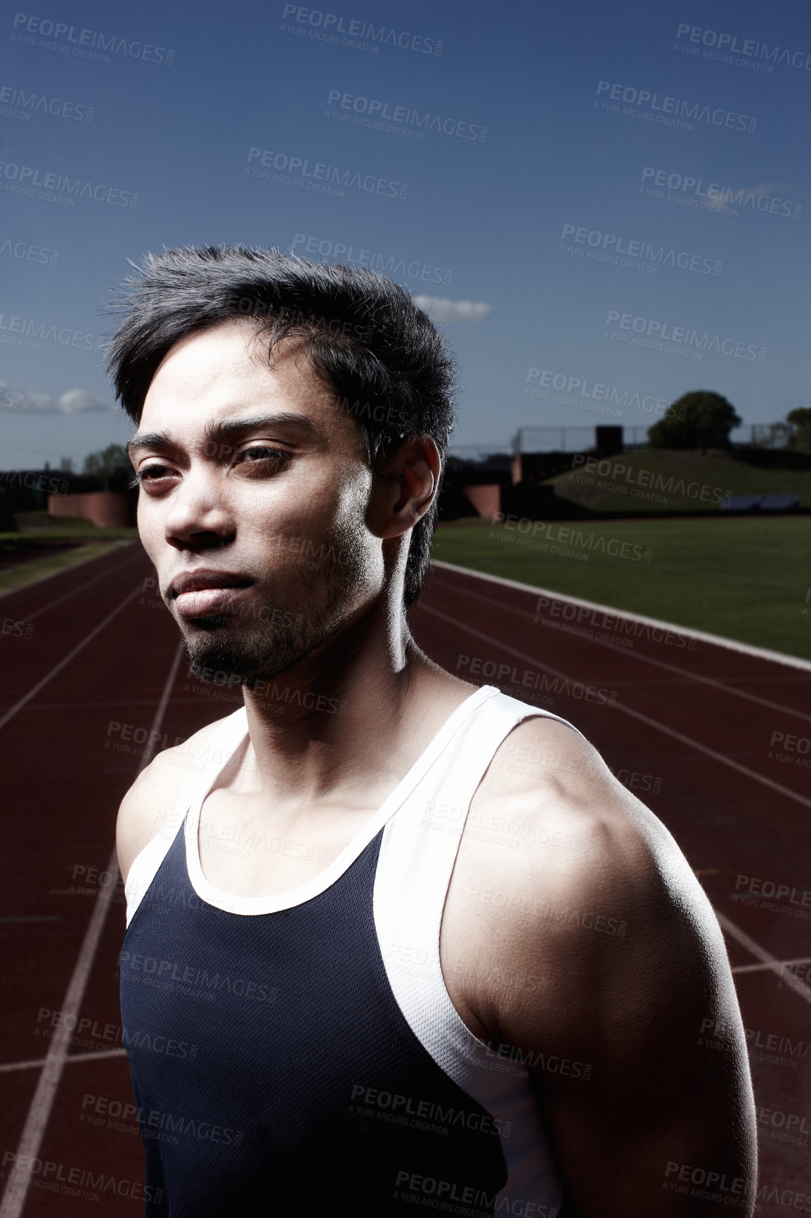 Buy stock photo Thinking, runner or face of man on track for training, late outdoor workout or sports exercise. Night, fitness ideas and confident male athlete in stadium for running development or race performance